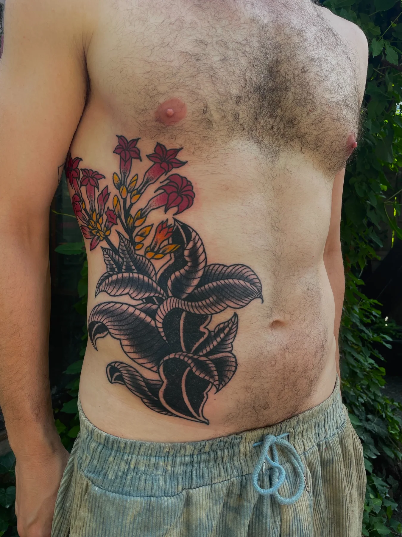 Botanical tattoo composition on torso
